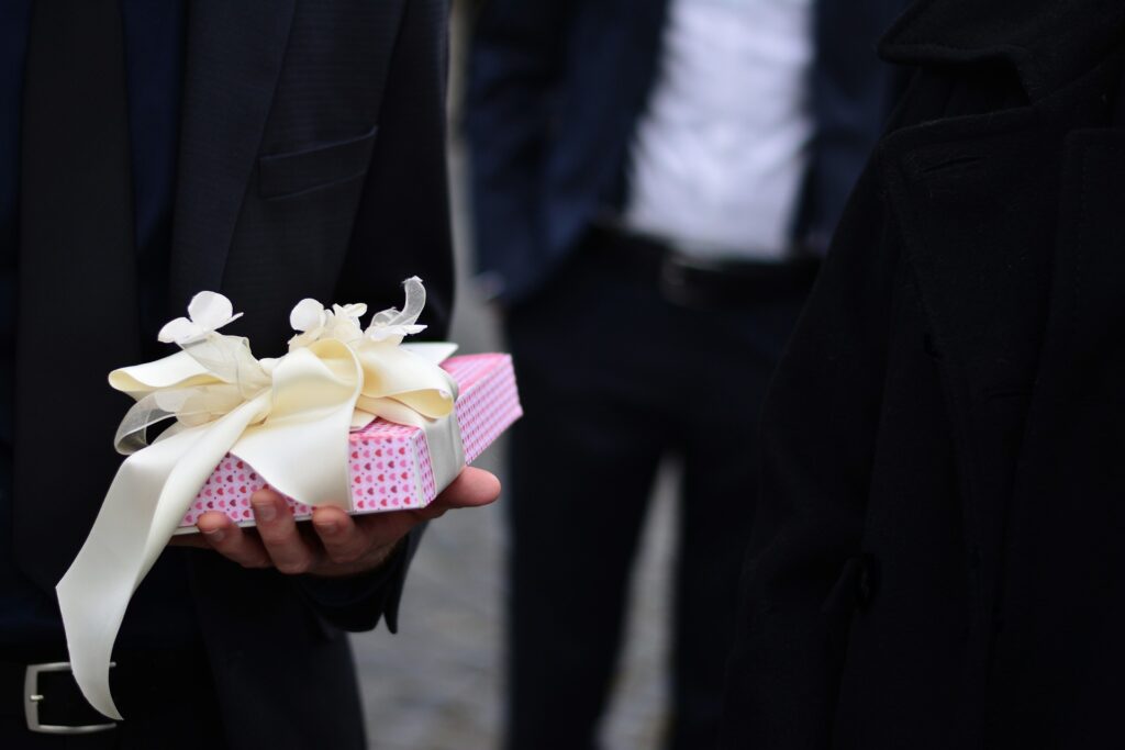 groom holding gift for bride